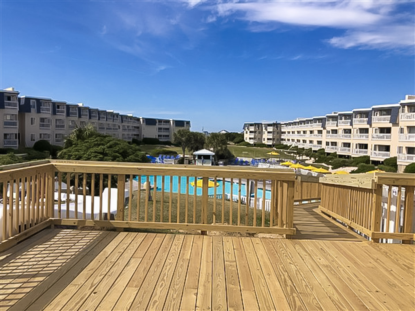 An overlook view of the pool and exterior of the building at VRI's A Place at the Beach in Atlantic Beach, NC.